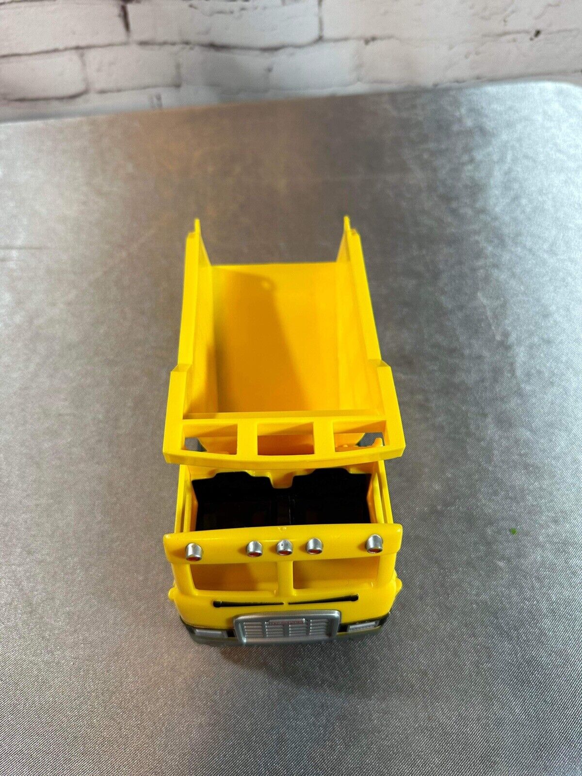 FISHER PRICE DUMP TRUCK PLASTIC 7"X 4" LEVER ACTION POPS UP BACK VTY