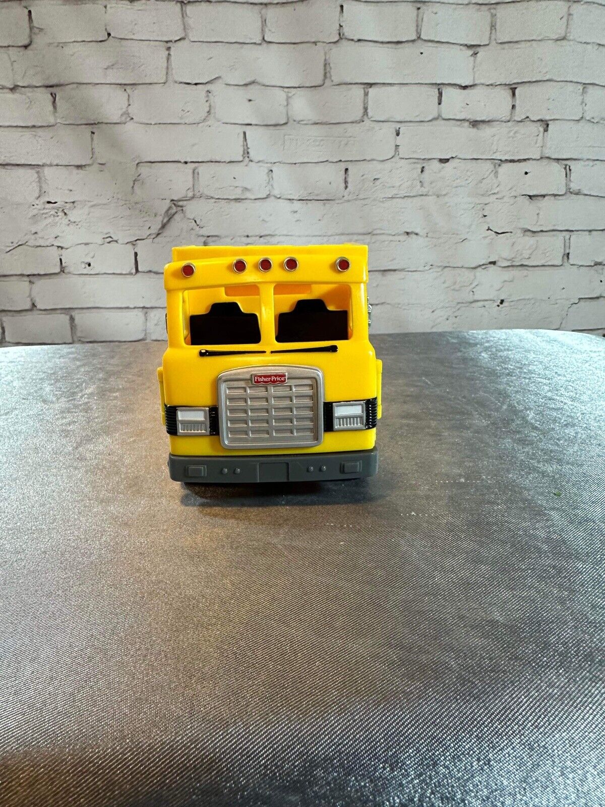 FISHER PRICE DUMP TRUCK PLASTIC 7"X 4" LEVER ACTION POPS UP BACK VTY