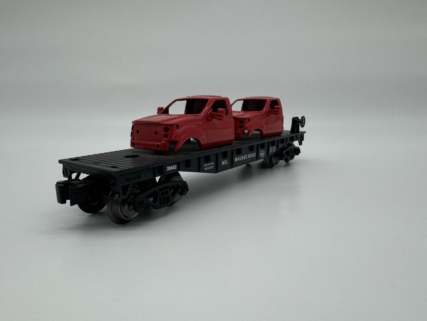 MENARD’S  GOLD LINE MILWAUKEE ROAD FLATCAR WITH TWO F150 CAB LOAD 279-266